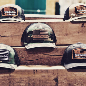 "We The Essentials" Multicam Green and Black Trucker Hat with Orange Patch
